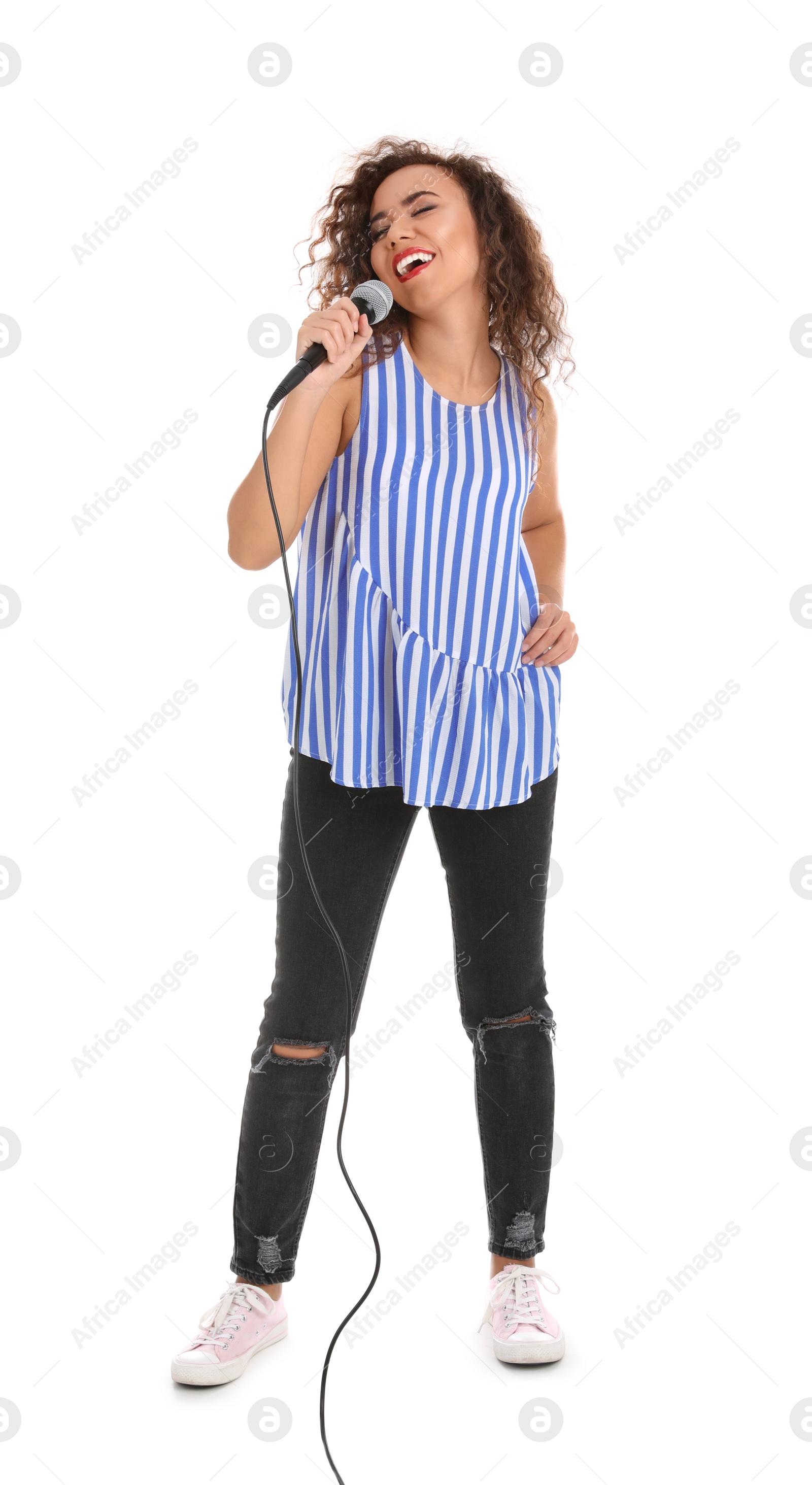 Photo of Curly African-American woman in casual clothes singing with microphone on white background