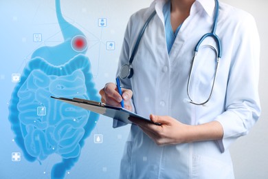 Image of Gastroenterologist holding clipboard and virtual image of intestine on light background, closeup