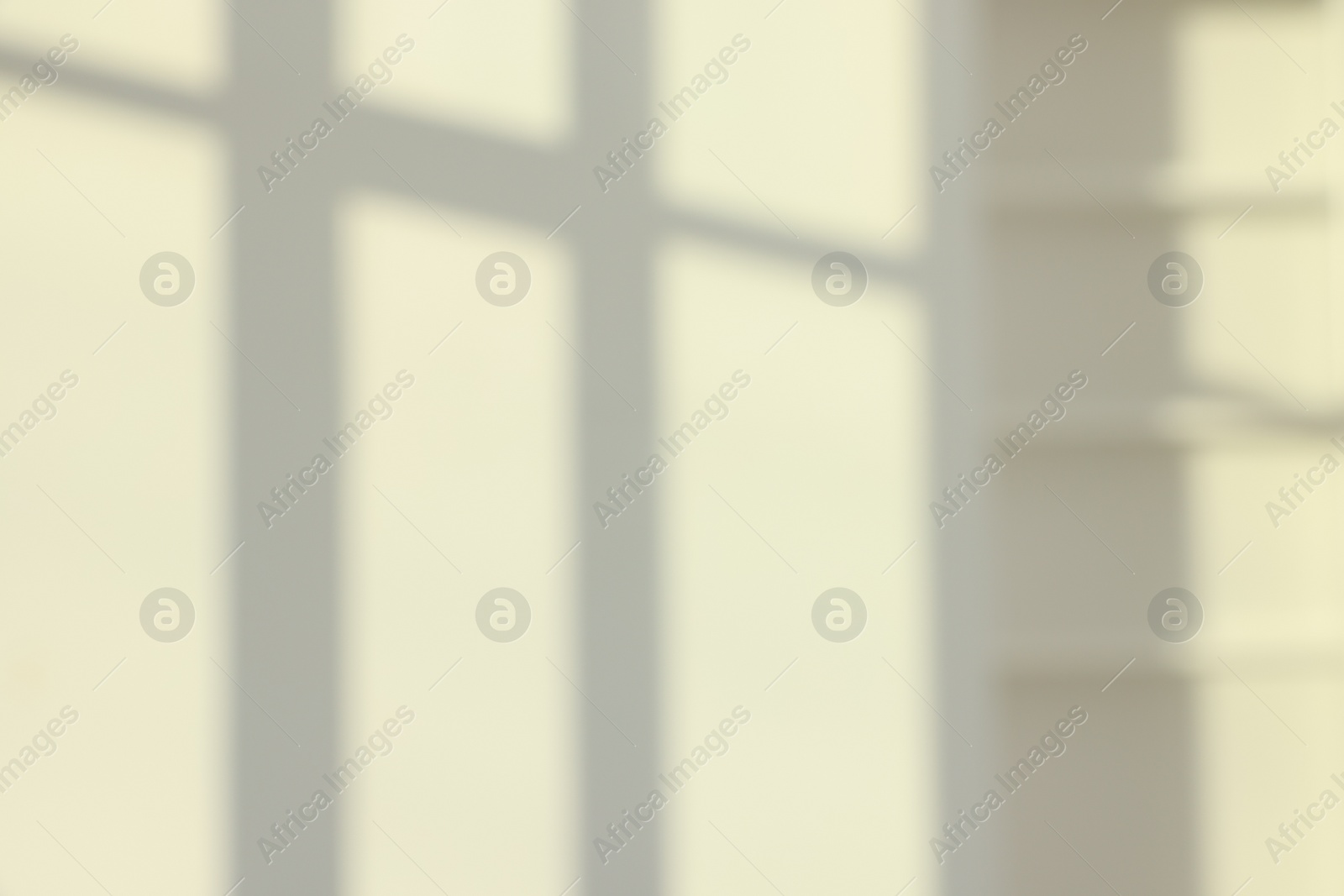 Photo of Light and shadows from window on wall indoors