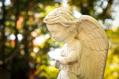 Beautiful statue of angel at cemetery, closeup. Religious symbol