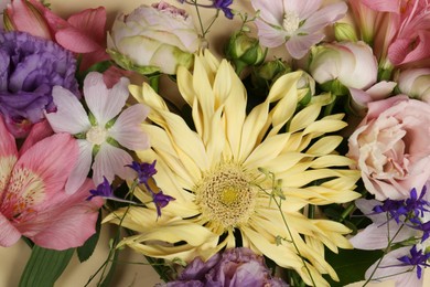 Photo of Different beautiful flowers on beige background, closeup