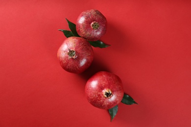 Flat lay composition with ripe pomegranates on color background