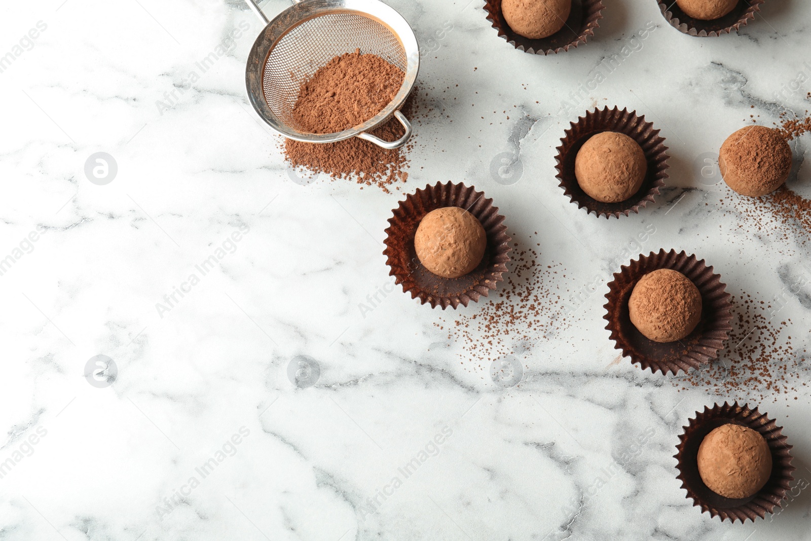 Photo of Flat lay composition with tasty raw chocolate truffles on marble background, space for text