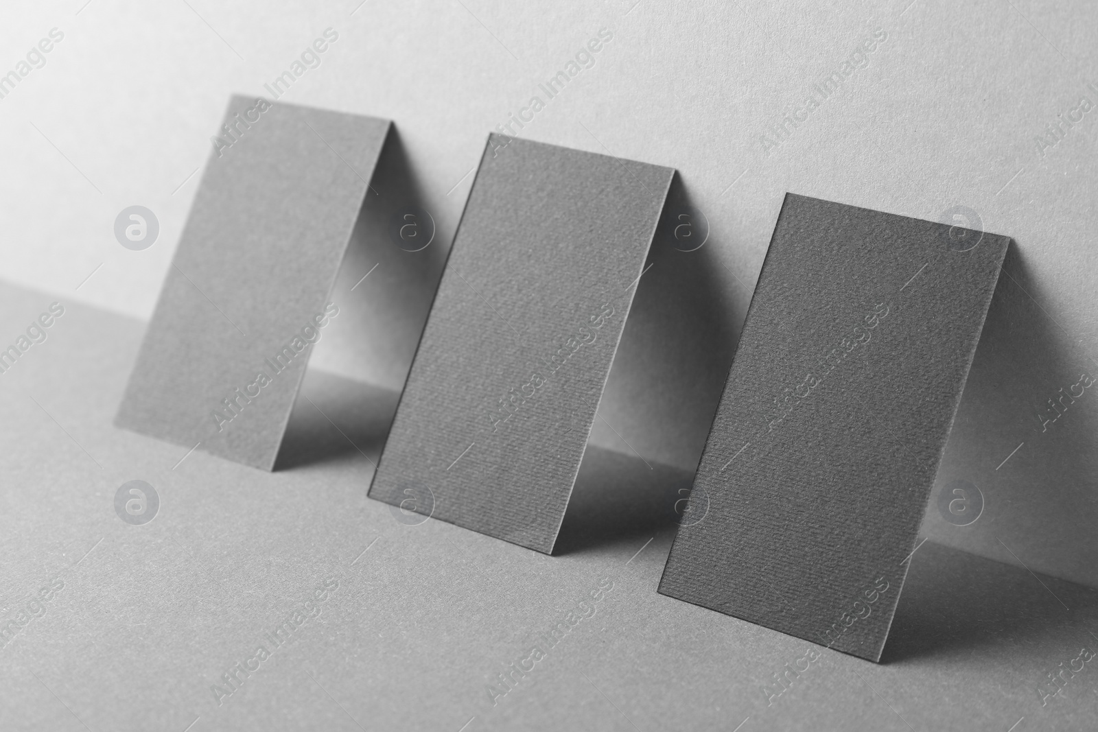 Photo of Blank black business cards on grey background. Mockup for design