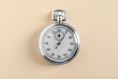 Photo of Vintage timer on beige background, top view. Measuring tool