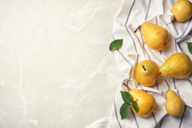 Ripe pears and striped fabric on grey background, top view. Space for text