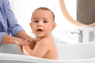 Photo of Mother with her little baby in bathroom