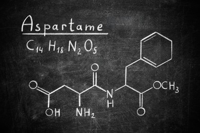 Image of Formula of aspartame (chemical and structural) written on blackboard. Sugar substitute