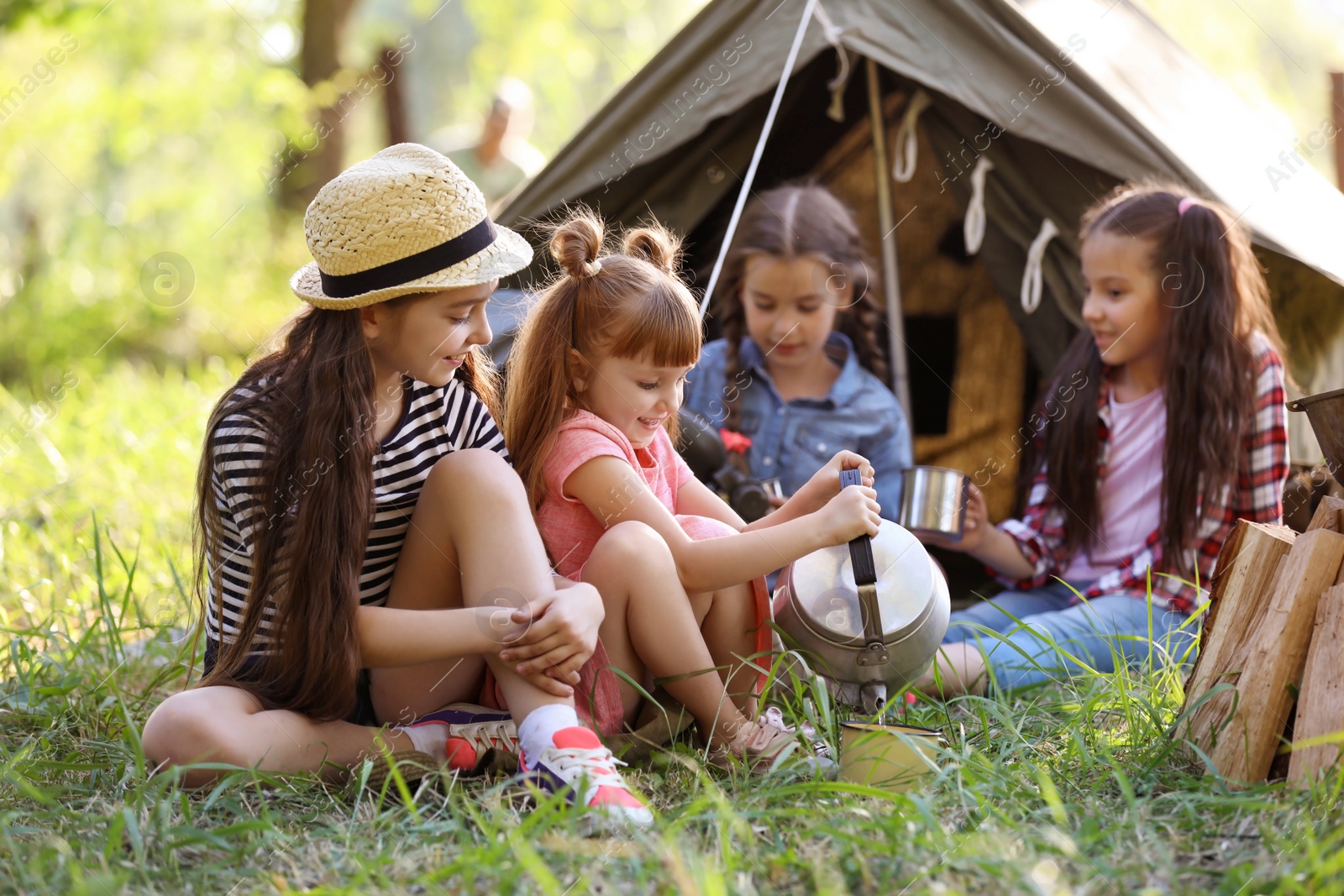 Photo of Little children near tent outdoors. Summer camp
