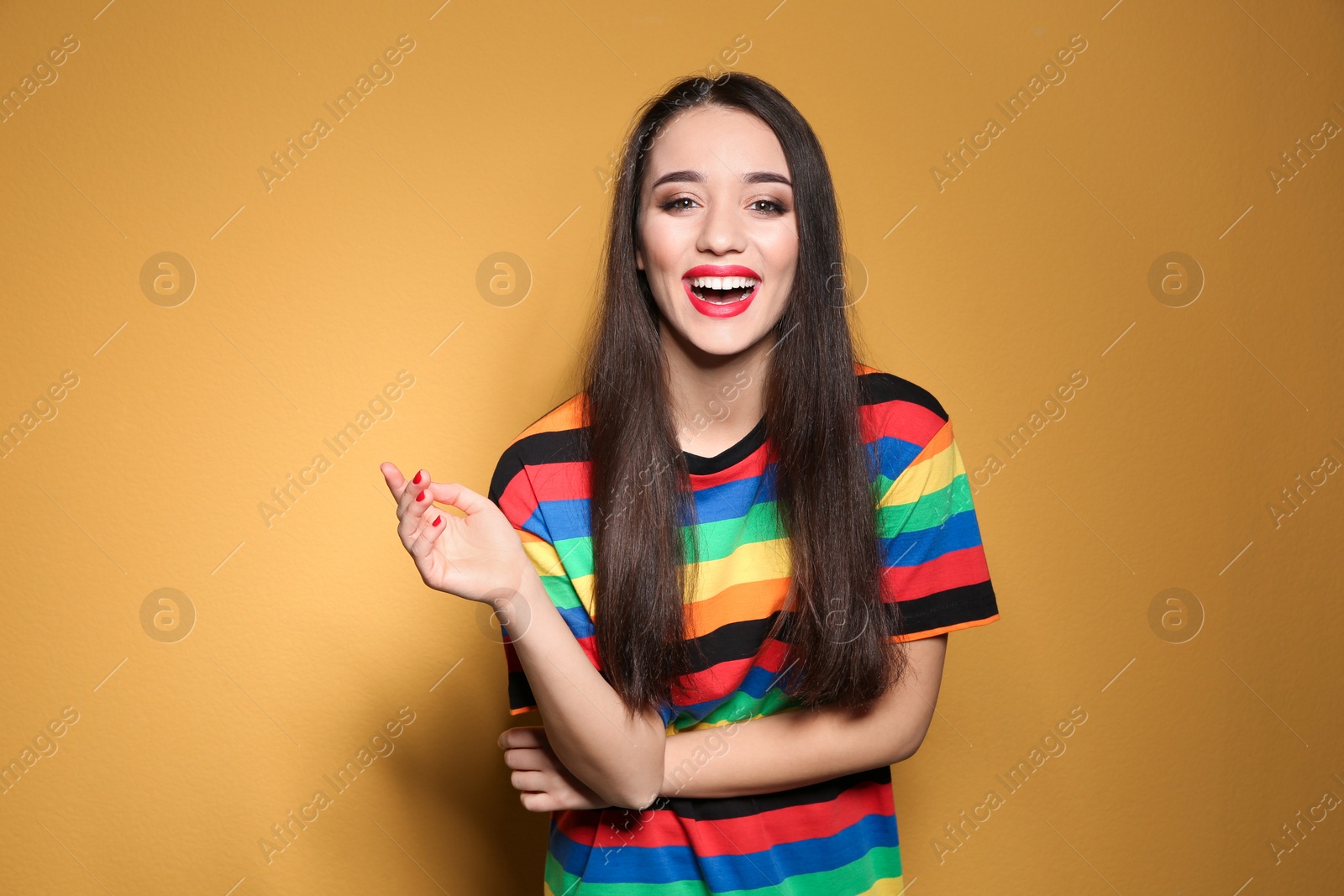 Photo of Portrait of beautiful young woman on colorful background
