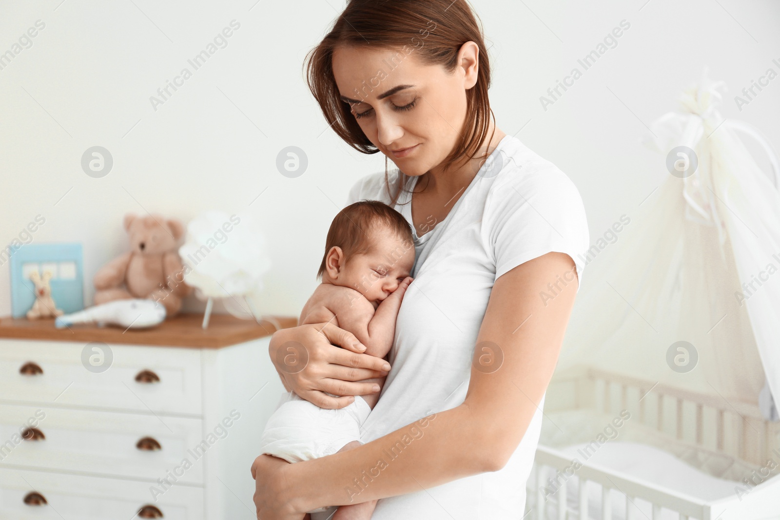 Photo of Young mother with her cute baby at home