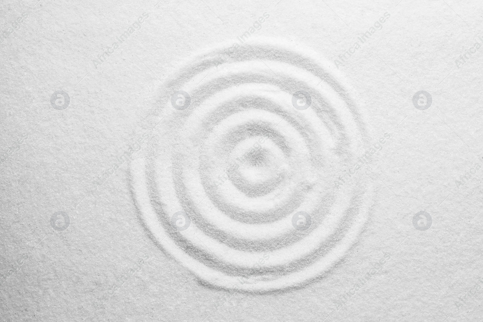 Photo of White sand with pattern as background, top view. Zen, meditation, harmony