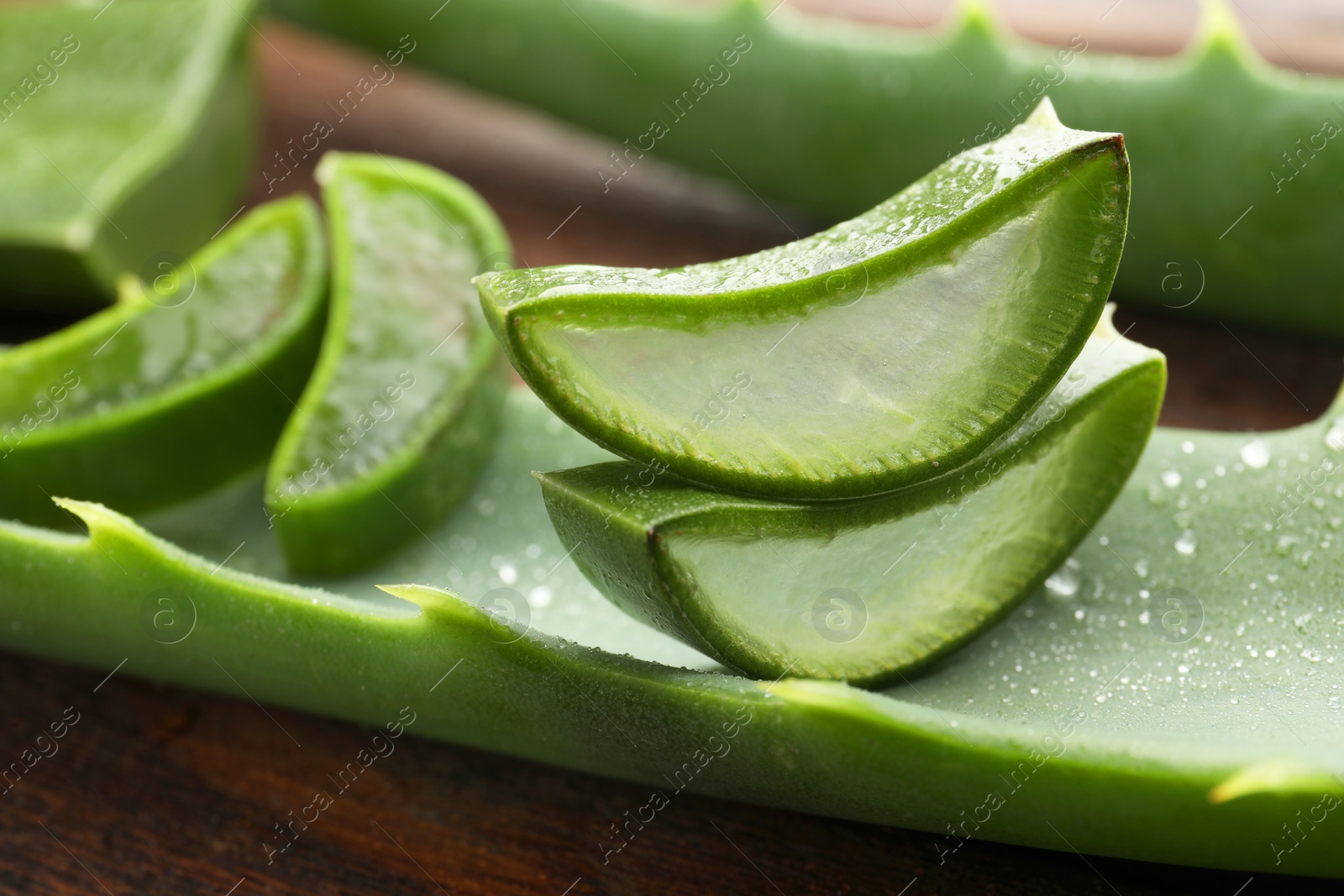 Photo of Fresh aloe vera pieces on table, closeup