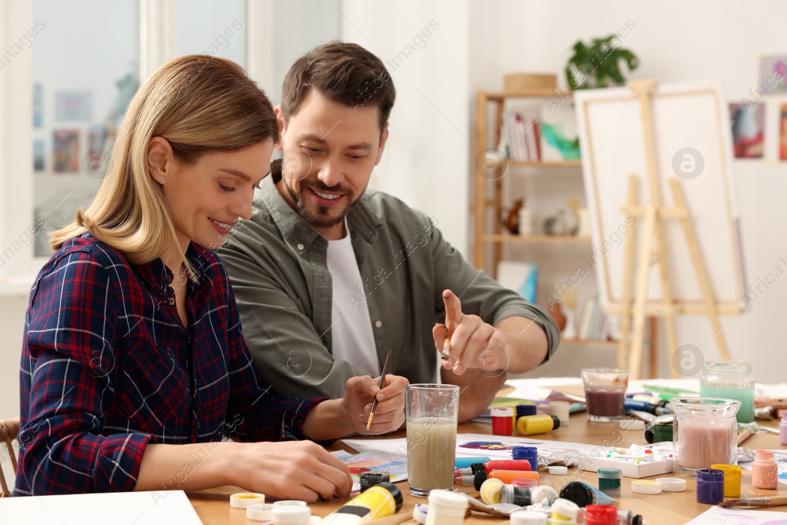 Photo of Students attending painting class in studio. Creative hobby