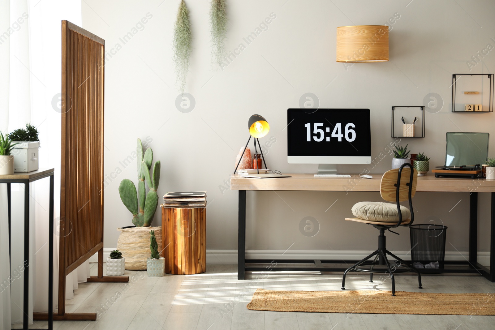 Photo of Room interior with comfortable workplace. Modern computer on wooden desk