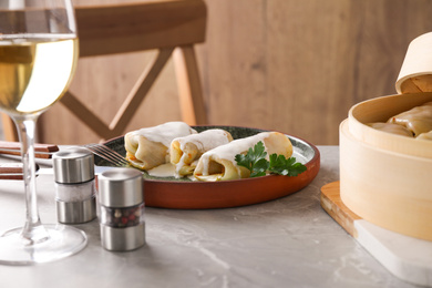 Delicious cabbage rolls served on grey marble table indoors