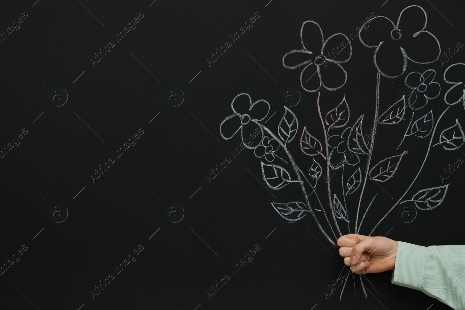 Photo of Woman near blackboard with chalk drawn bouquet, closeup. Space for text