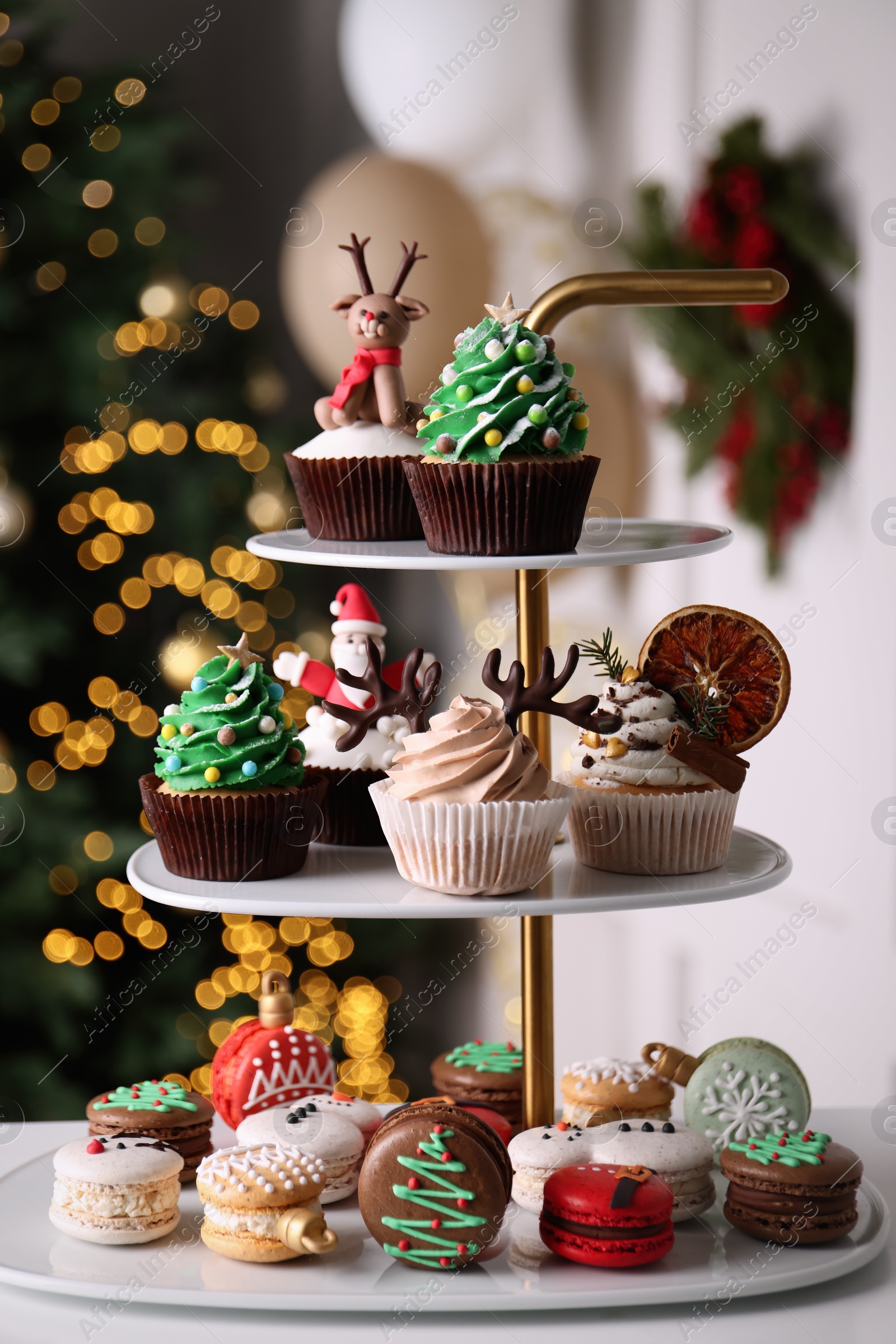 Photo of Many different Christmas cupcakes on white table indoors