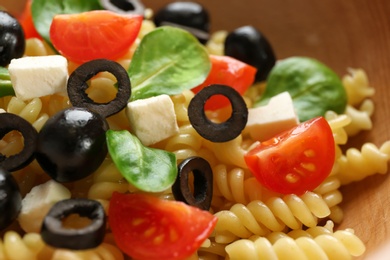 Delicious pasta primavera with olives and cherry tomatoes, closeup