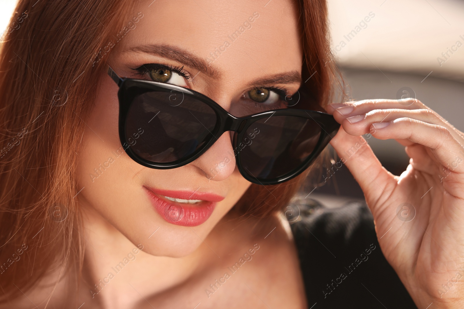 Photo of Beautiful woman in sunglasses outdoors on sunny day, closeup