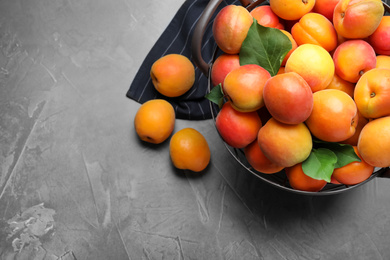 Delicious fresh ripe apricots on dark table, flat lay. Space for text