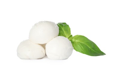 Delicious mozzarella cheese balls and basil on white background