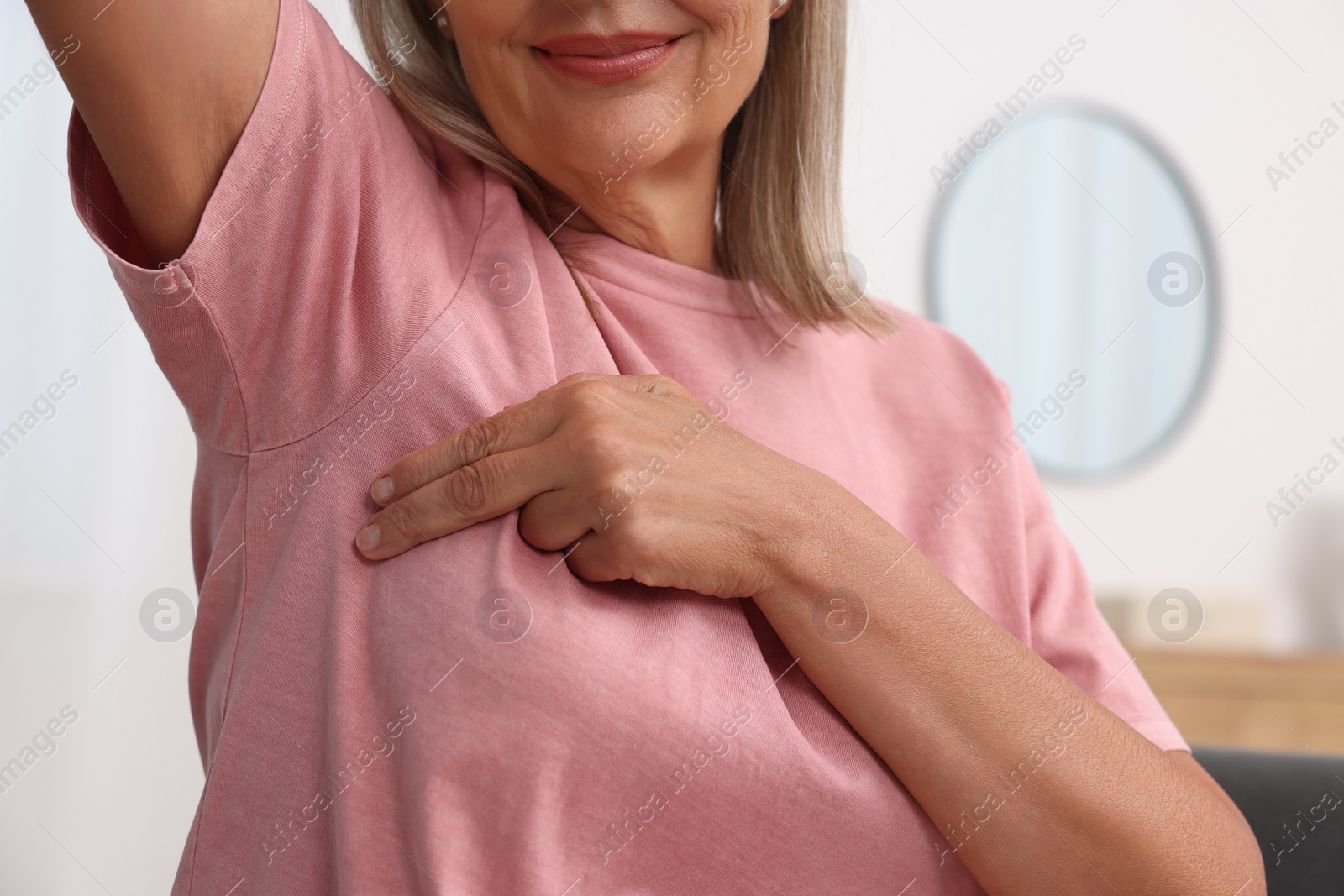 Photo of Woman doing breast self-examination at home, closeup