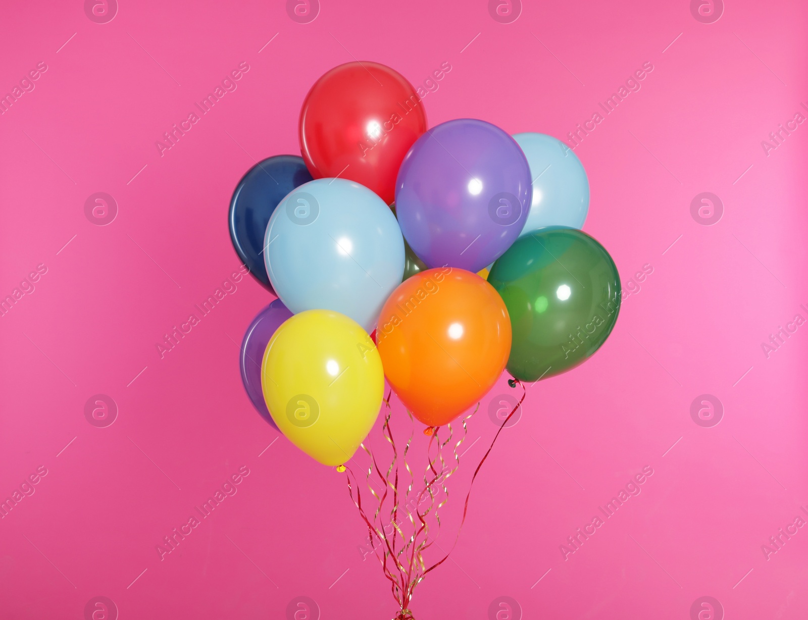 Photo of Bunch of bright balloons on color background