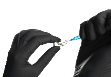 Doctor in medical gloves with syringe and ampoule on white background