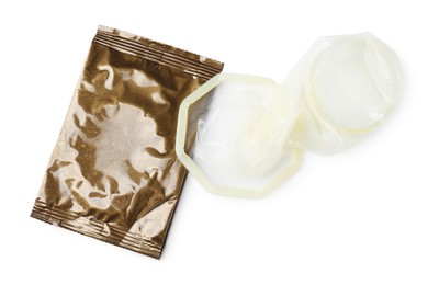 Unpacked female condom and package isolated on white, top view. Safe sex