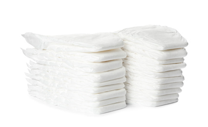 Photo of Stacks of baby diapers isolated on white