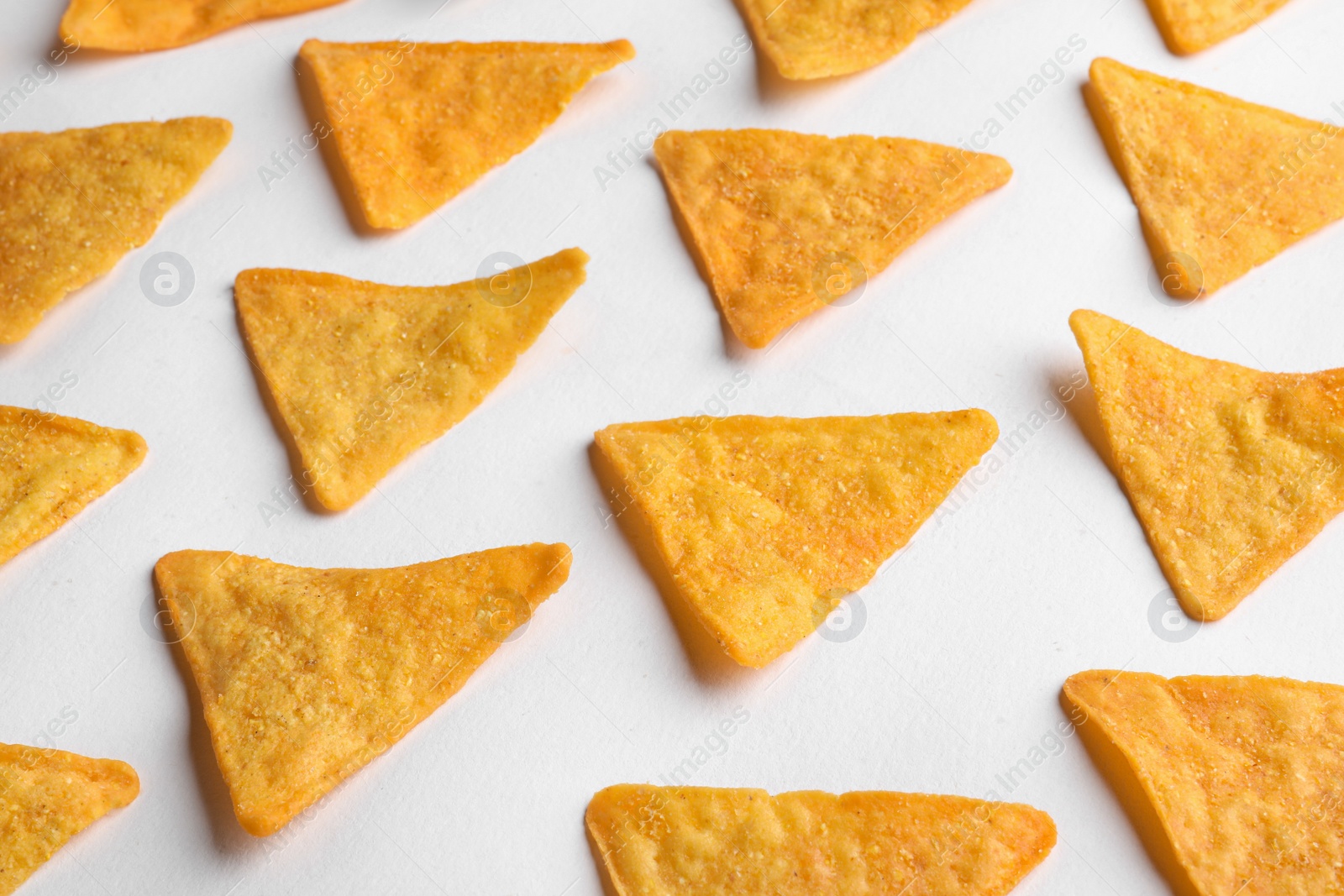 Photo of Tasty tortilla chips (nachos) on white background