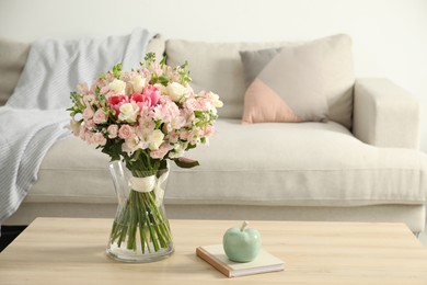 Photo of Beautiful bouquet of fresh flowers in vase on wooden table indoors, space for text