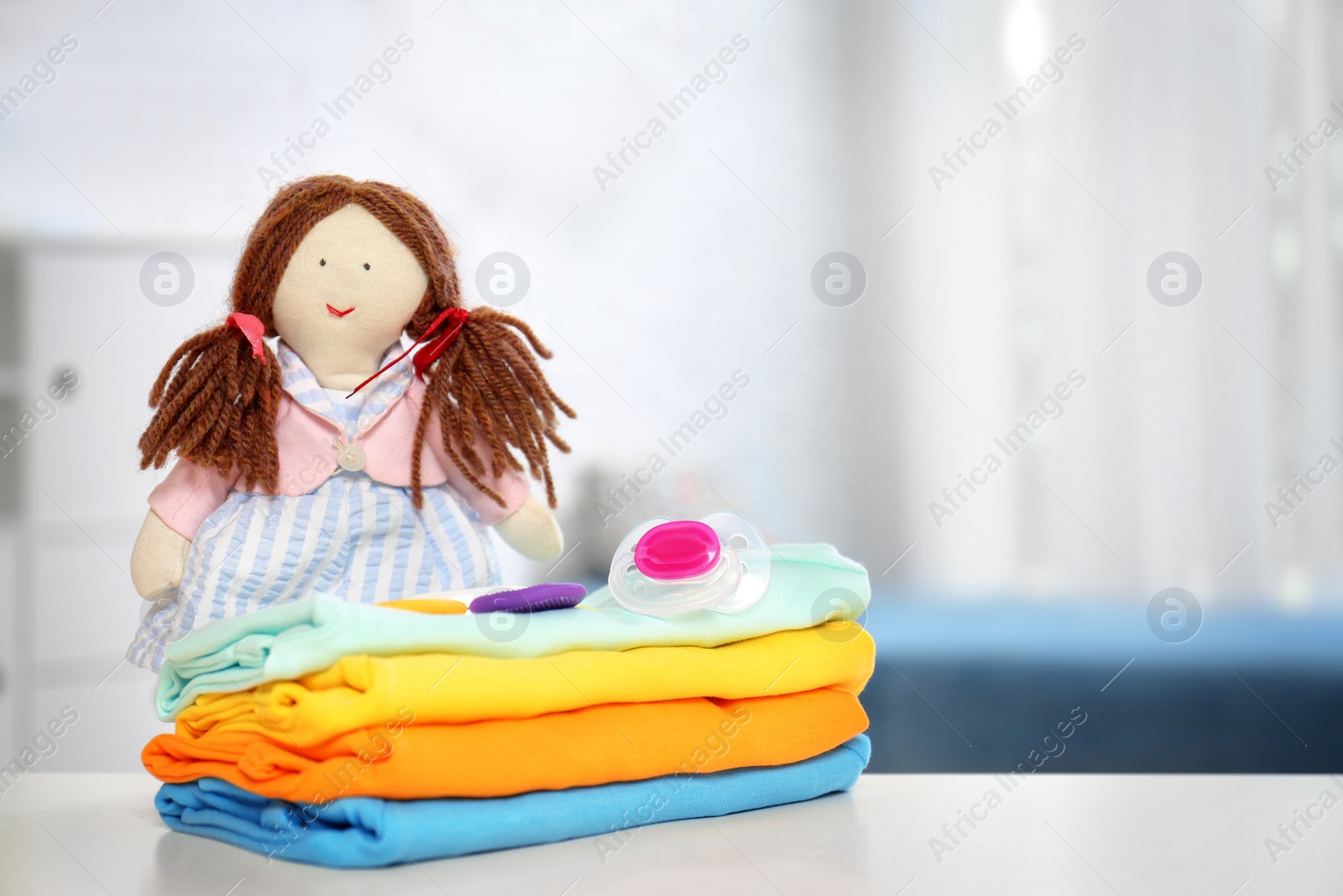 Photo of Baby accessories on table in nursery room. Space for text