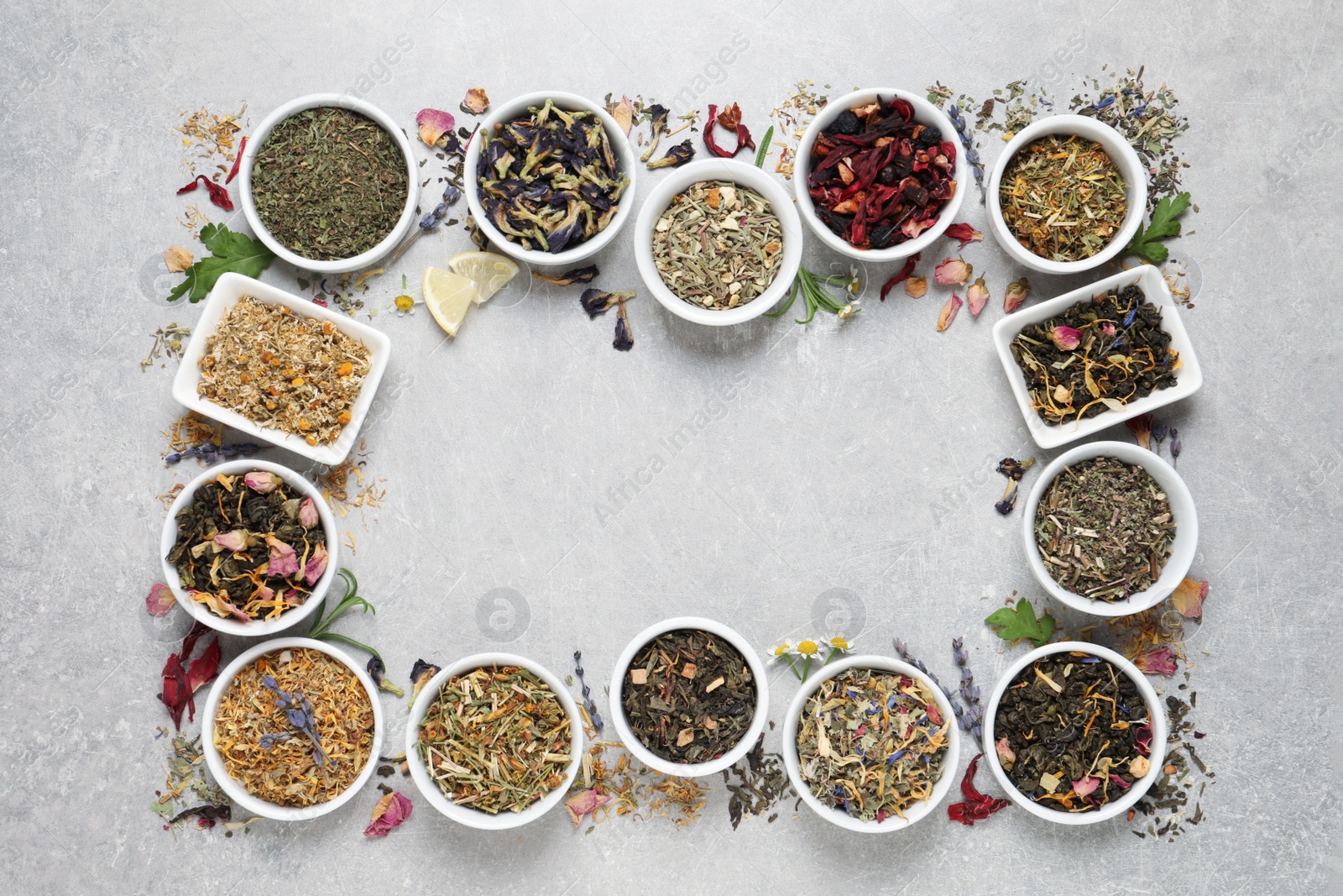 Photo of Frame of different dry teas on light grey table, flat lay. Space for text