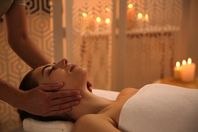 Young woman receiving body massage in spa salon