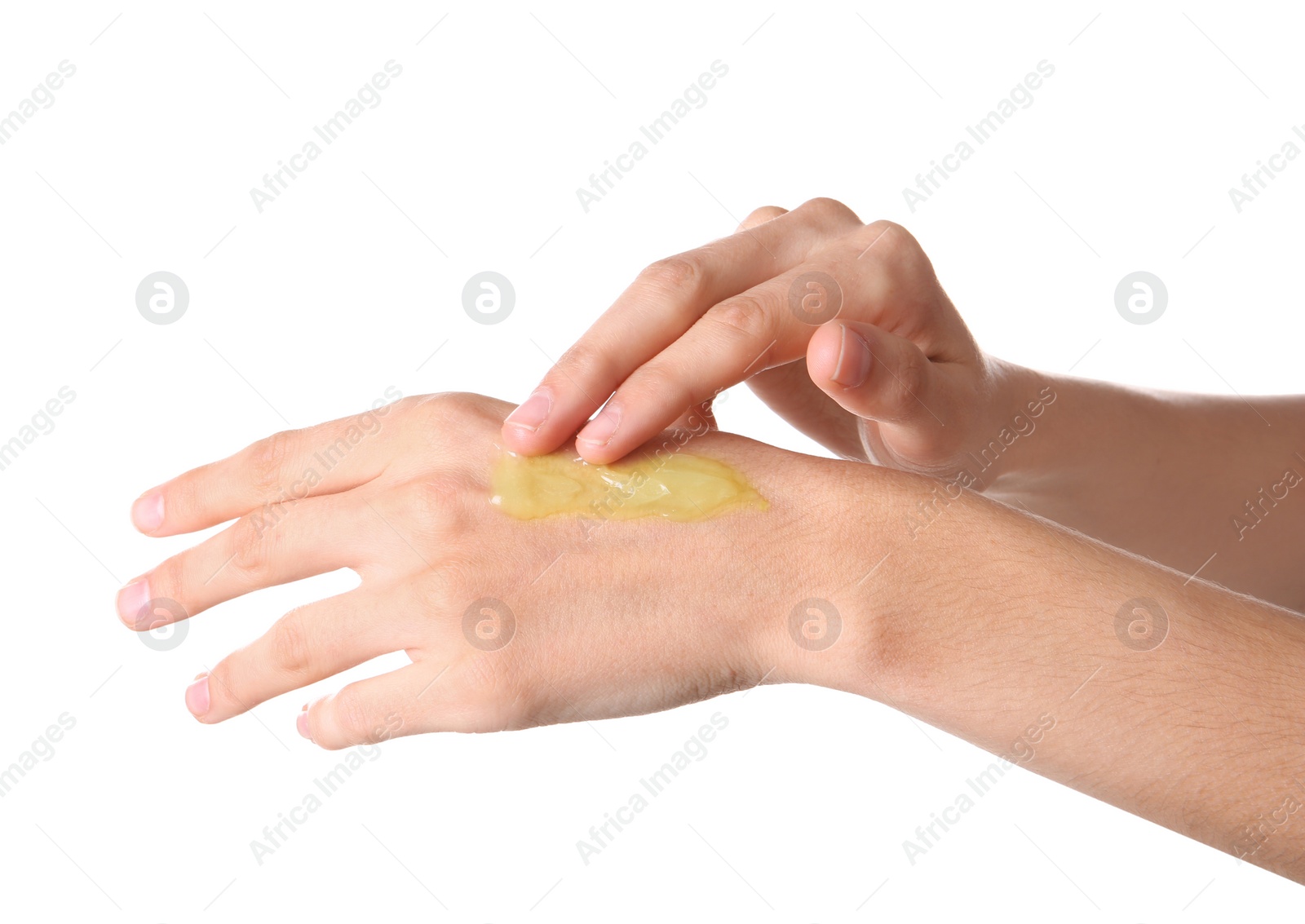 Photo of Woman applying hemp lotion on hand against white background, closeup