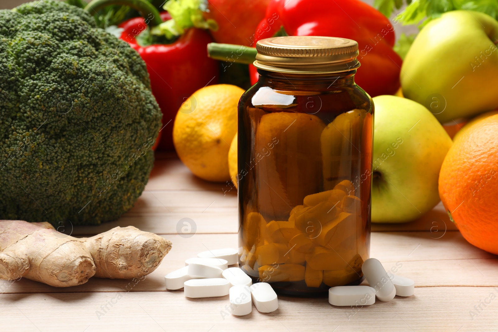 Photo of Dietary supplements. Bottle with pills near food products on light wooden table