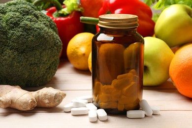 Photo of Dietary supplements. Bottle with pills near food products on light wooden table