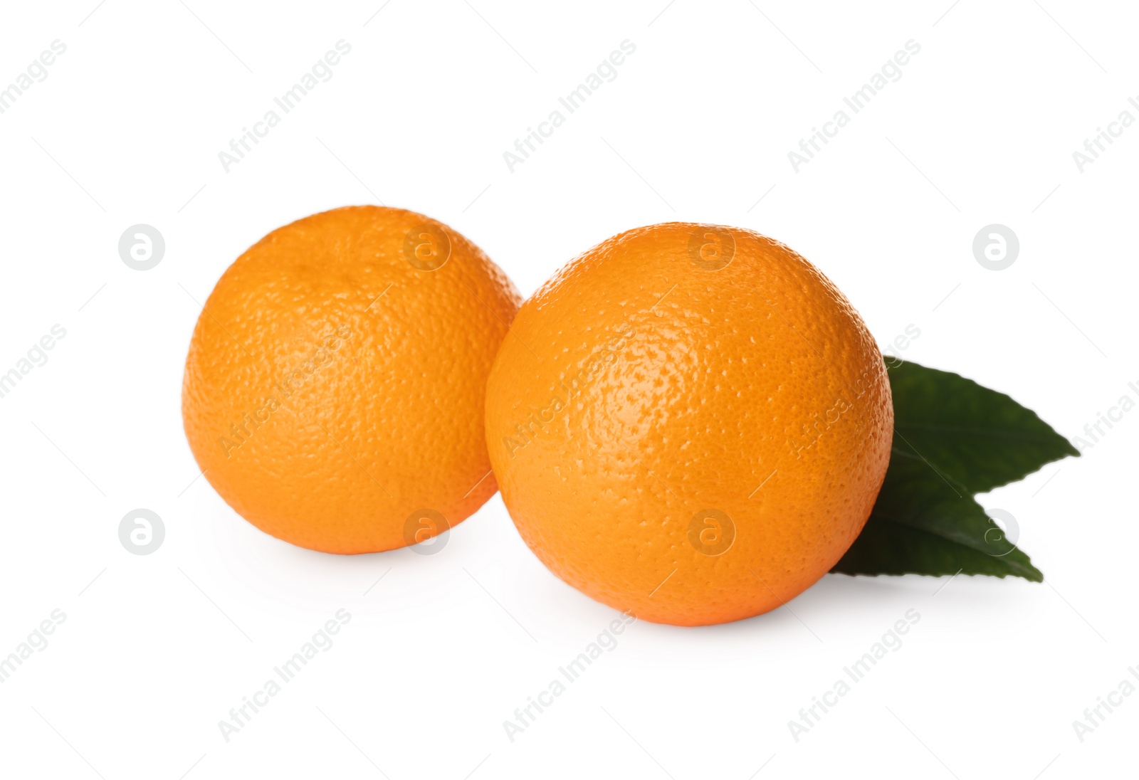 Photo of Fresh ripe oranges with green leaves on white background