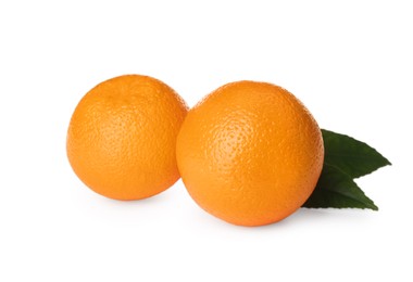 Photo of Fresh ripe oranges with green leaves on white background