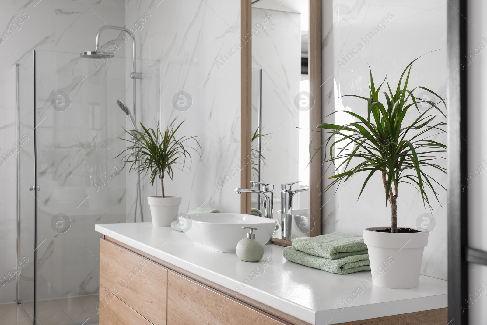 Photo of Large mirror and vessel sink in bathroom