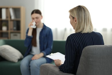 Photo of Professional psychotherapist working with patient in office