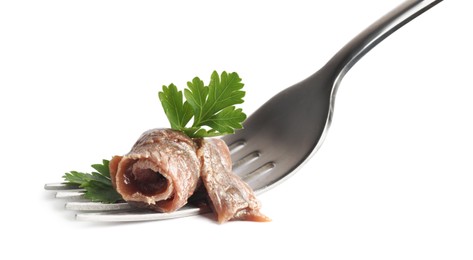 Fork with delicious anchovy fillet and parsley isolated on white