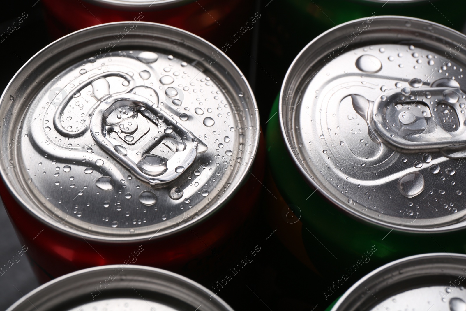 Photo of Energy drink in wet cans, closeup. Functional beverage