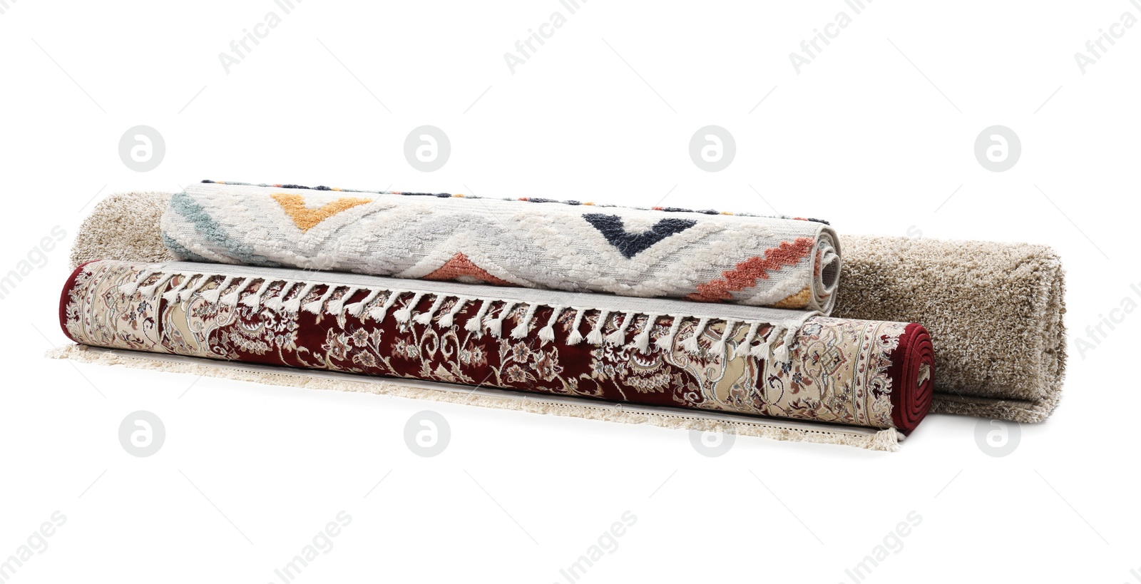 Photo of Rolled carpets on white background. Interior element