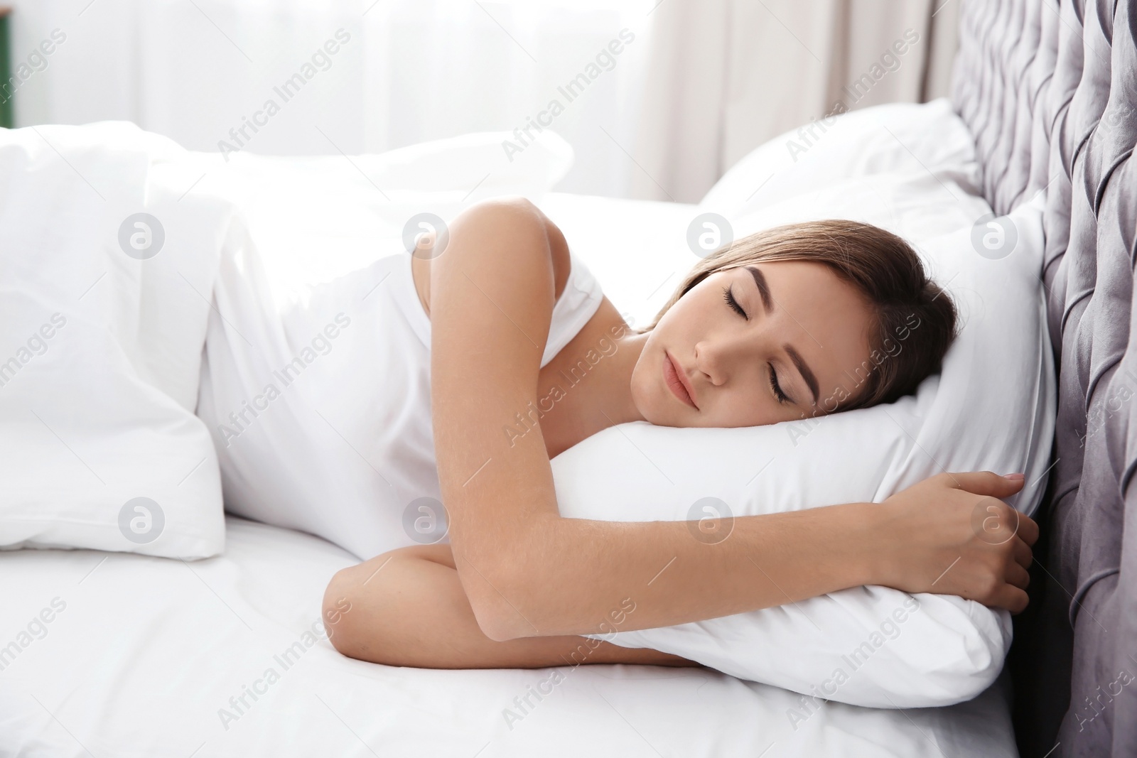 Photo of Beautiful teen girl sleeping with comfortable pillow in bed at home