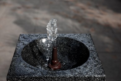 Drinking fountain with running water on city street