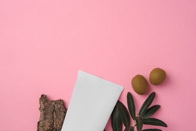 Photo of Natural cosmetic. Flat lay composition with olive cream on pink background. Space for text