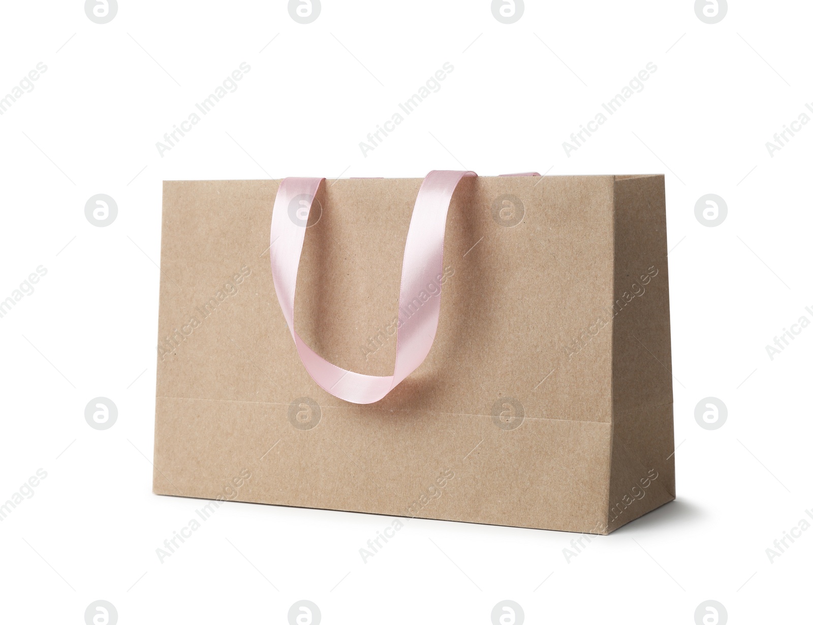 Photo of Paper shopping bag with ribbon handles on white background. Mockup for design